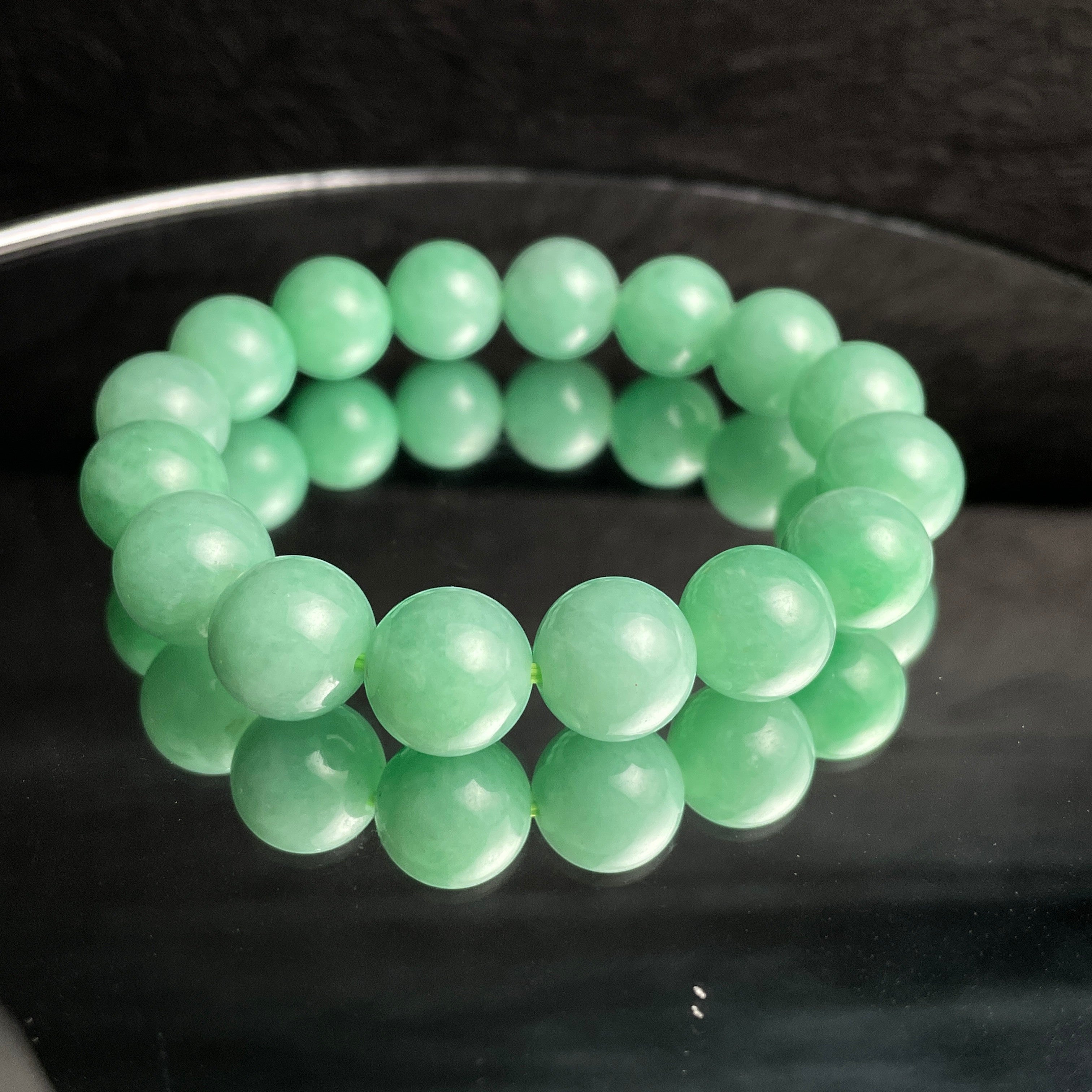 Sylvia Jewelry 14mm smooth green jadeite bead bracelet with natural luster, ideal for daily wear.