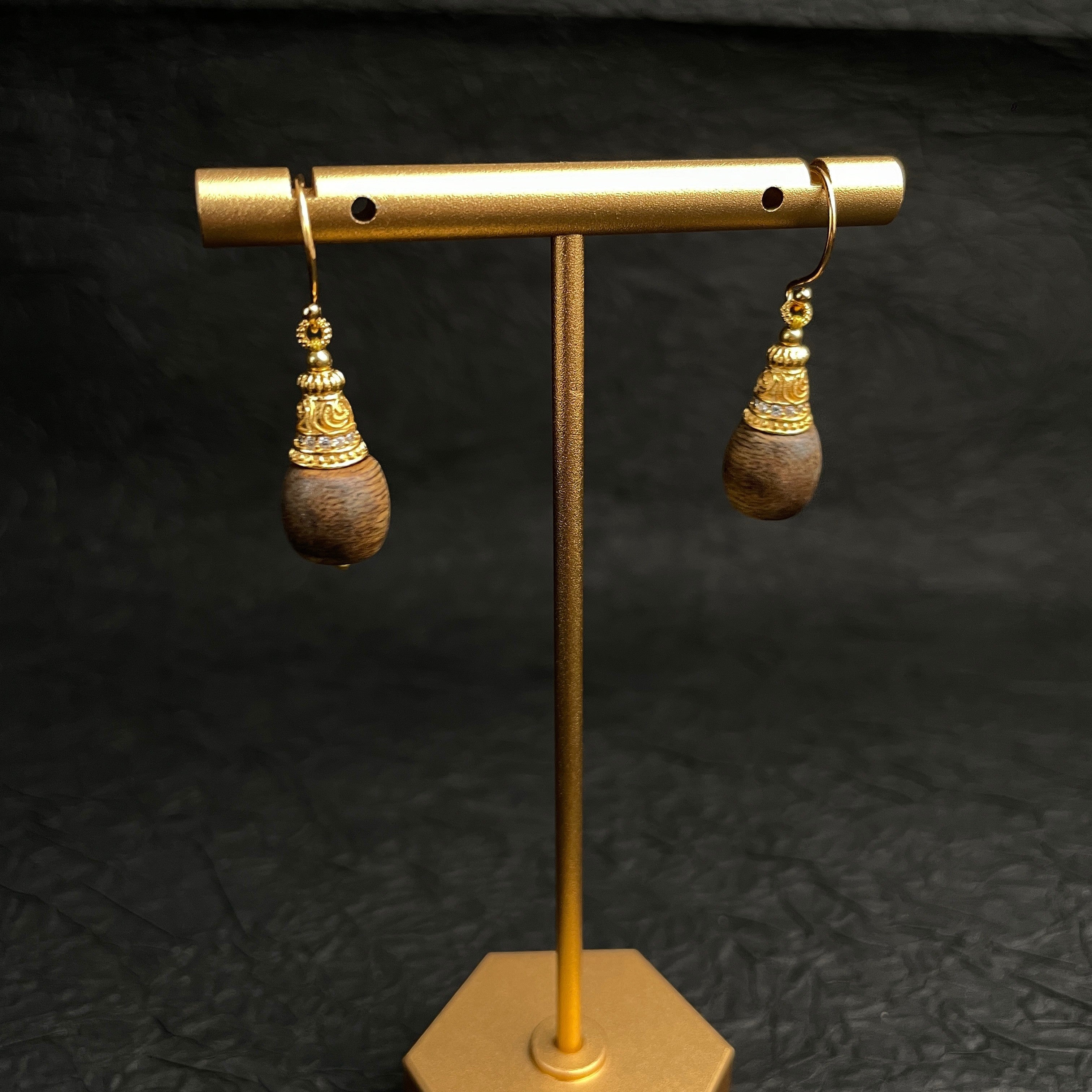 Sylvia Jewelry Zen Drop earrings featuring natural agarwood droplets with crystal-paved gold filigree caps on wire hooks.