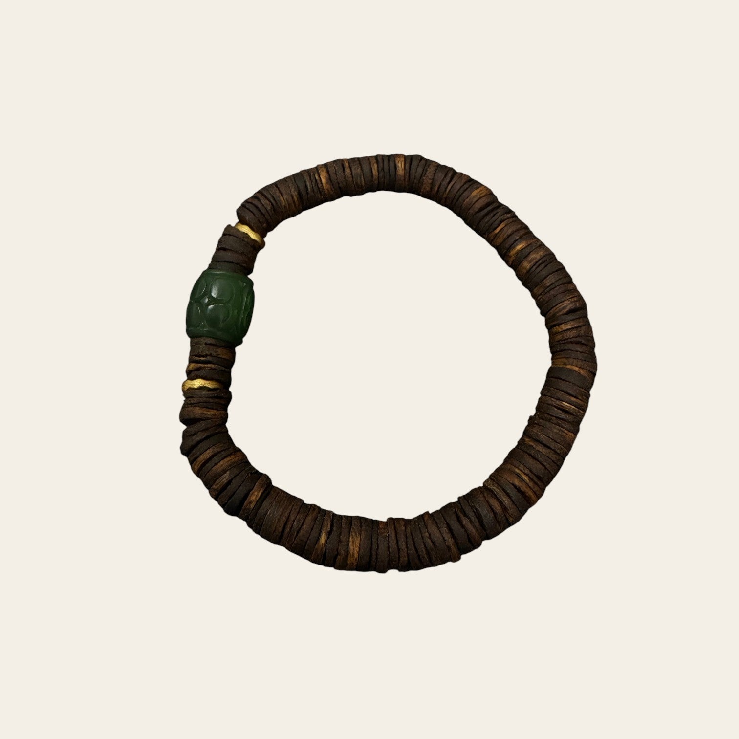 Sylvia Jewelry agarwood bead bracelet with a carved green jade cylinder centerpiece and gold-tone accents.