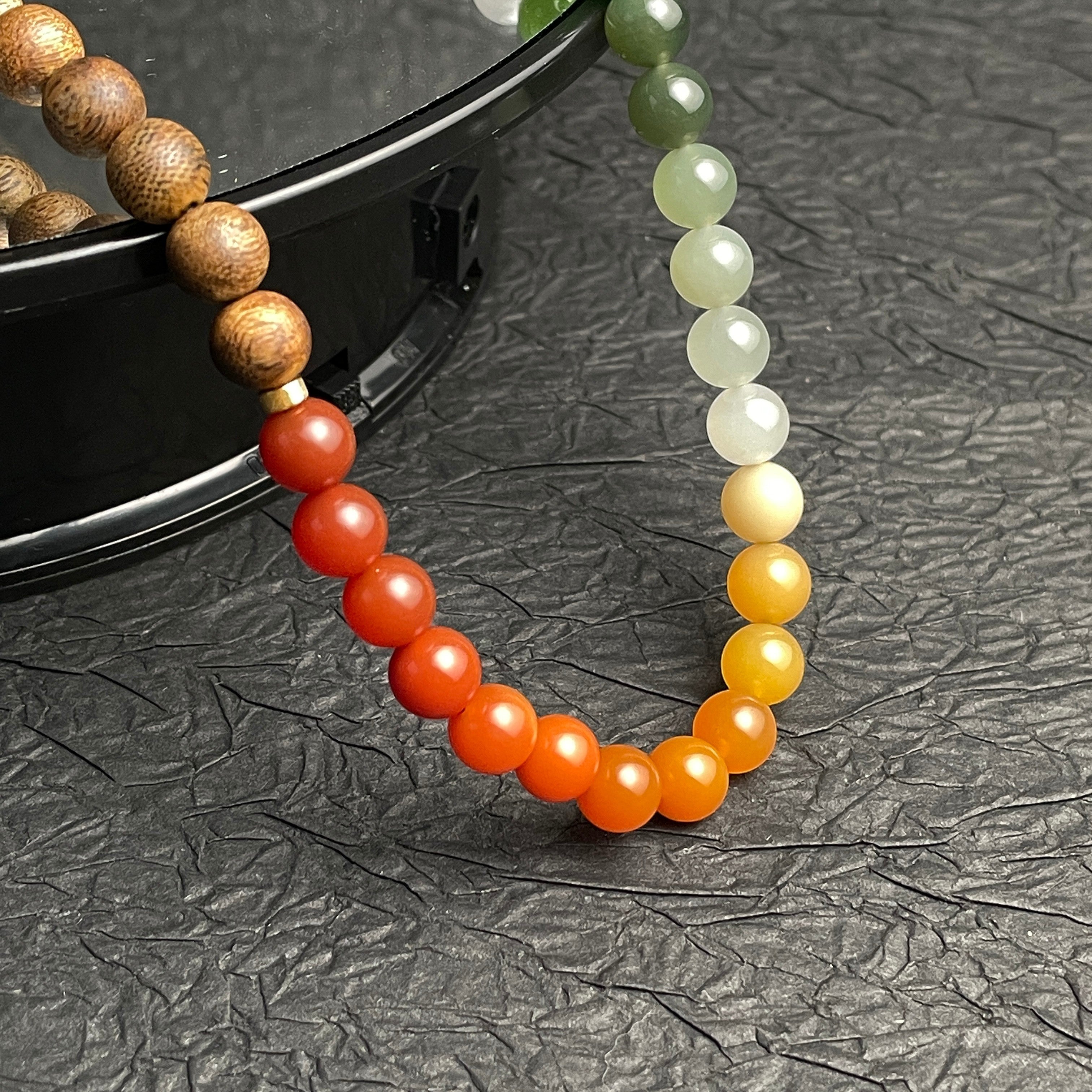 Sylvia Jewelry multi-wrap bracelet featuring natural agarwood beads and a gradient of multi-colored Hetian nephrite jade