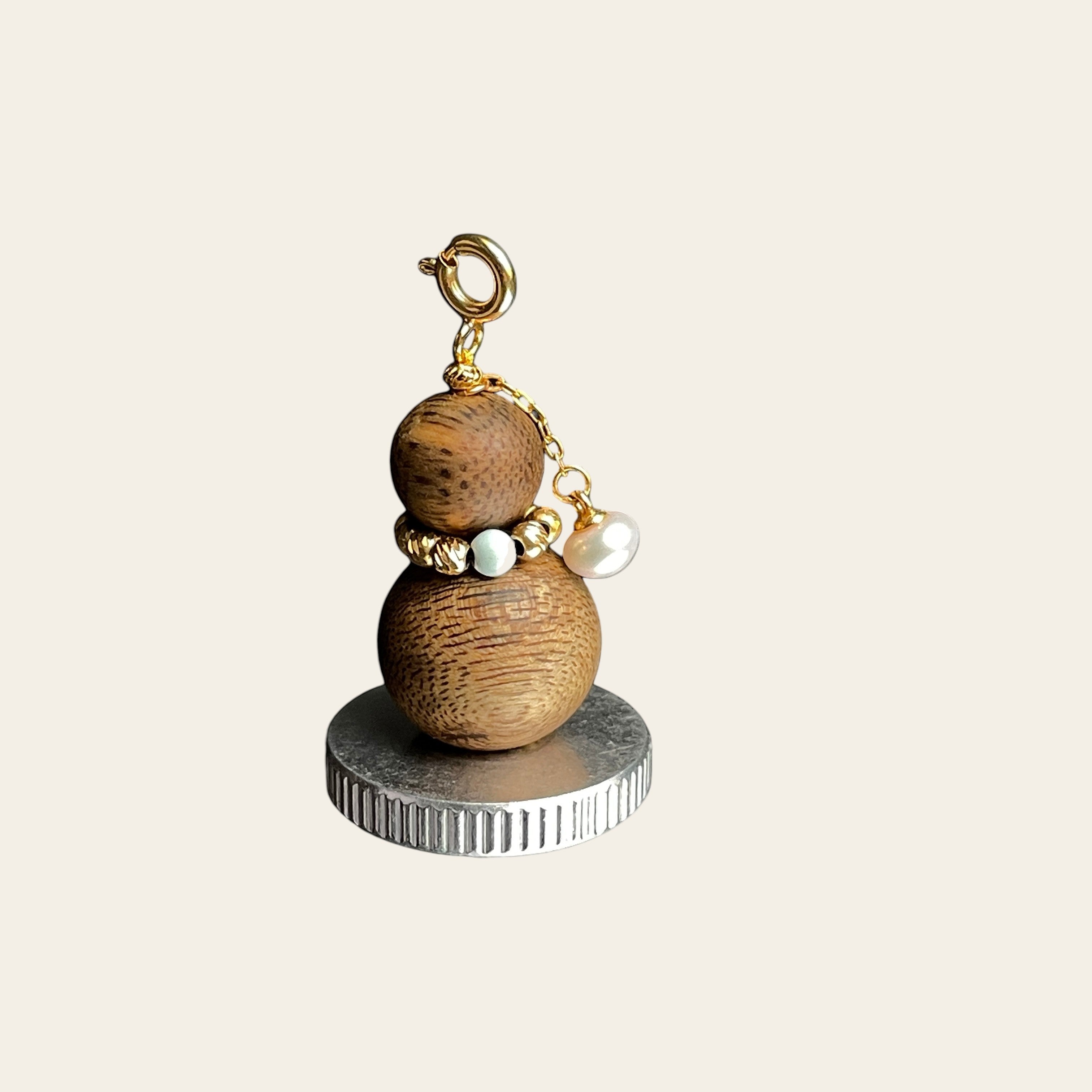 Sylvia Jewelry aromatic agarwood Wu Lou charm with turquoise bead, freshwater pearl, and gold-plated hardware.