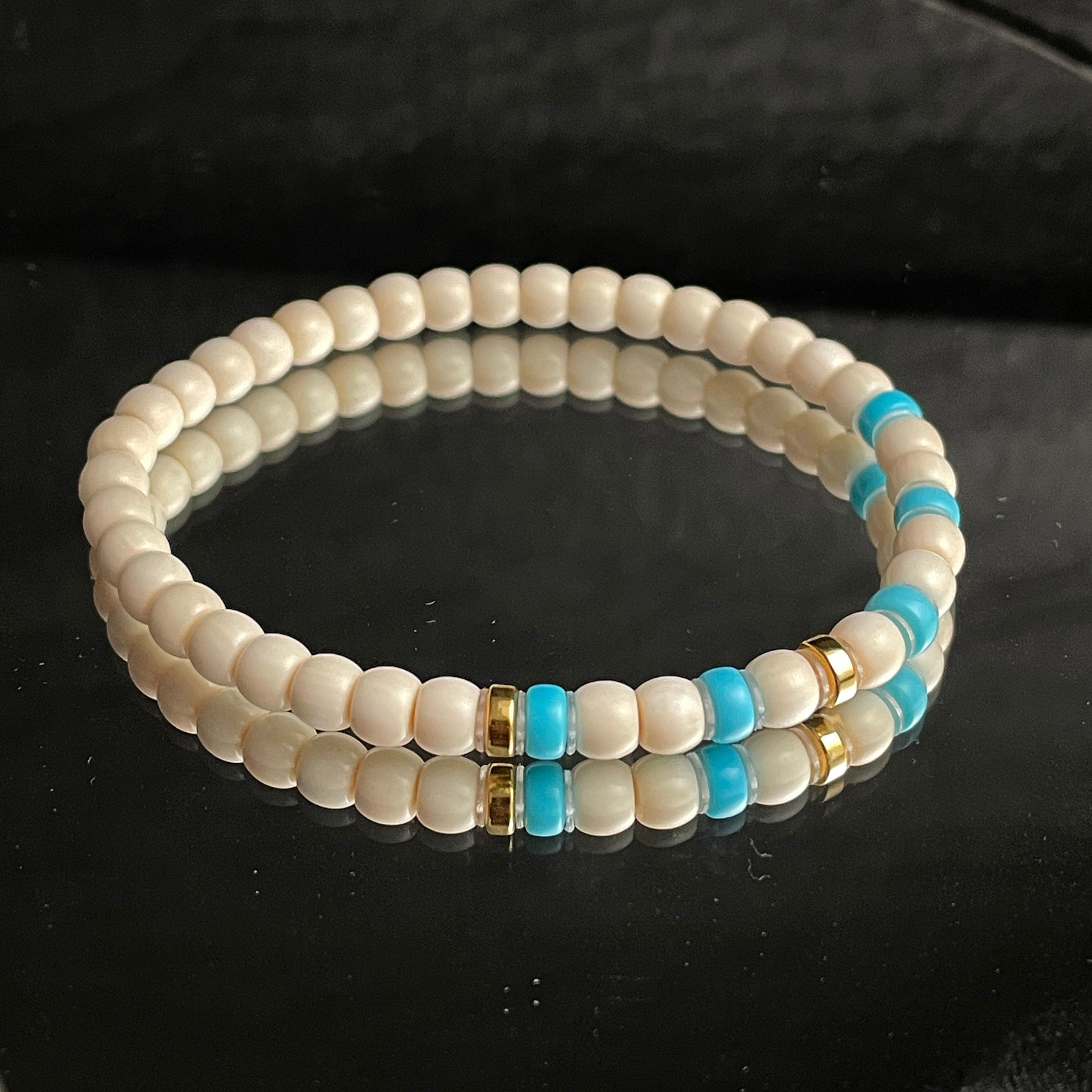 Sylvia Jewelry cream-colored beaded bracelet with turquoise accents and gold spacers, designed for daily wear.