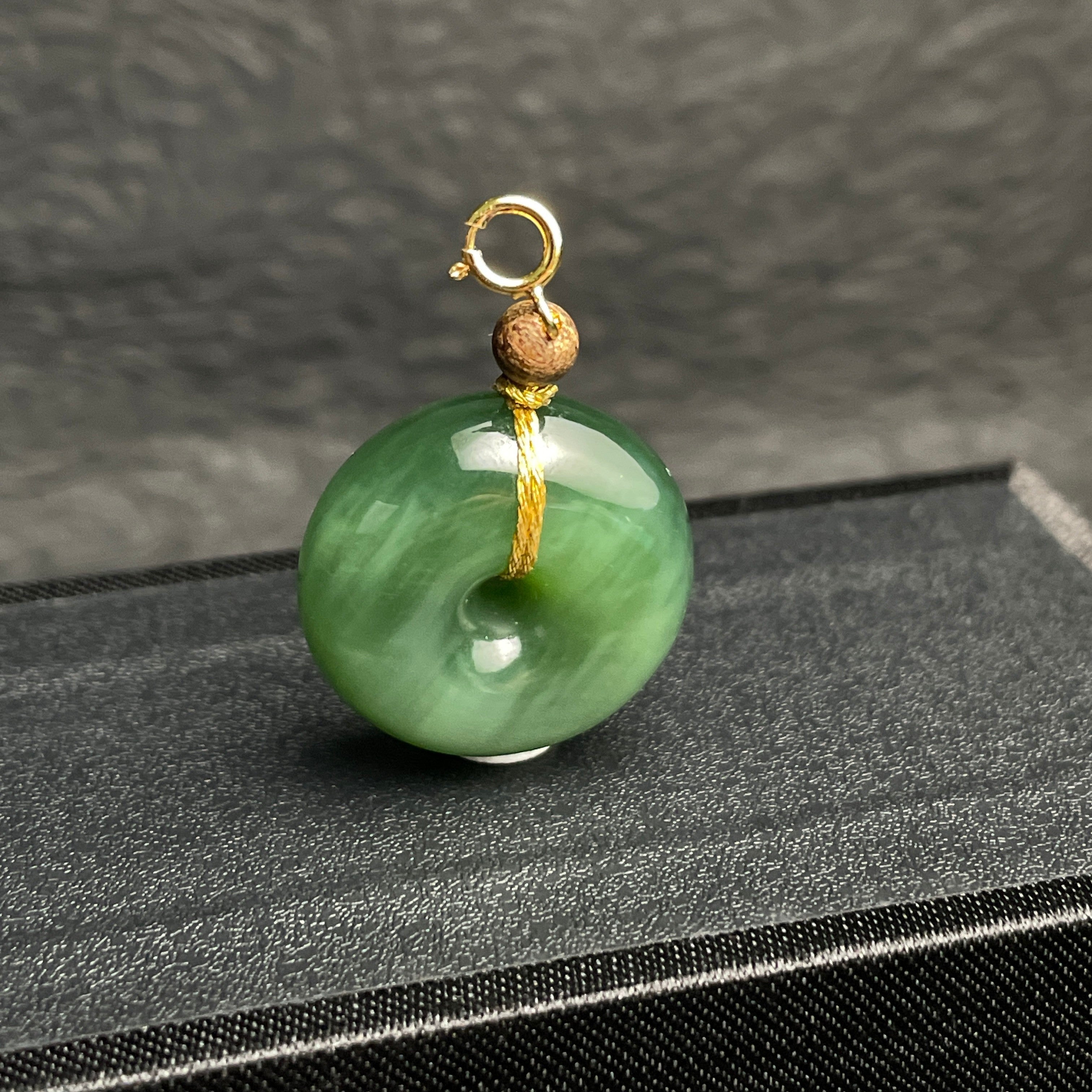 Sylvia Jewelry green jade donut pendant with a gold jump ring and small wooden bead accent