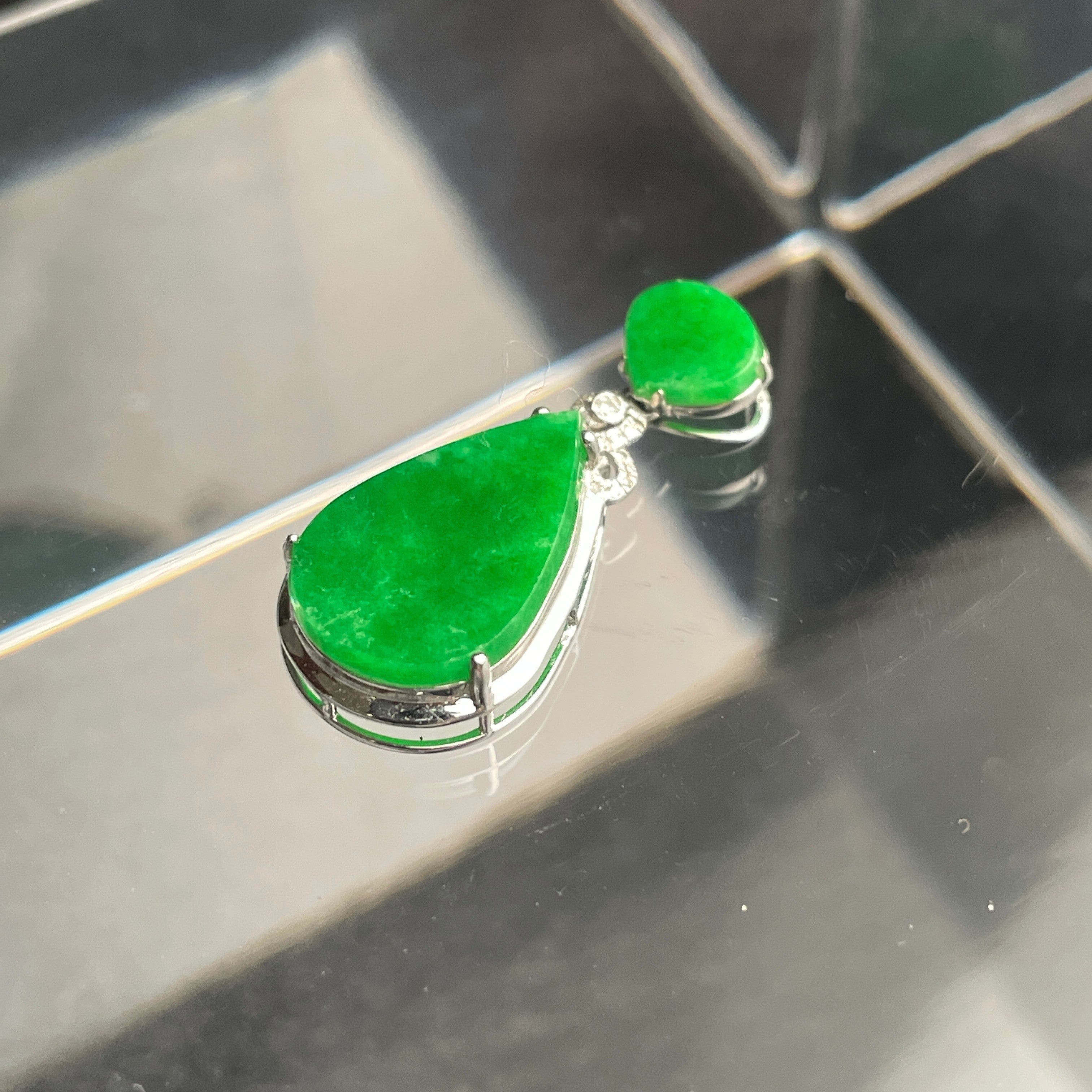 Sylvia Jewelry 18K gold teardrop pendant featuring vivid green jadeite, diamond accents, and a floral-inspired bail.
