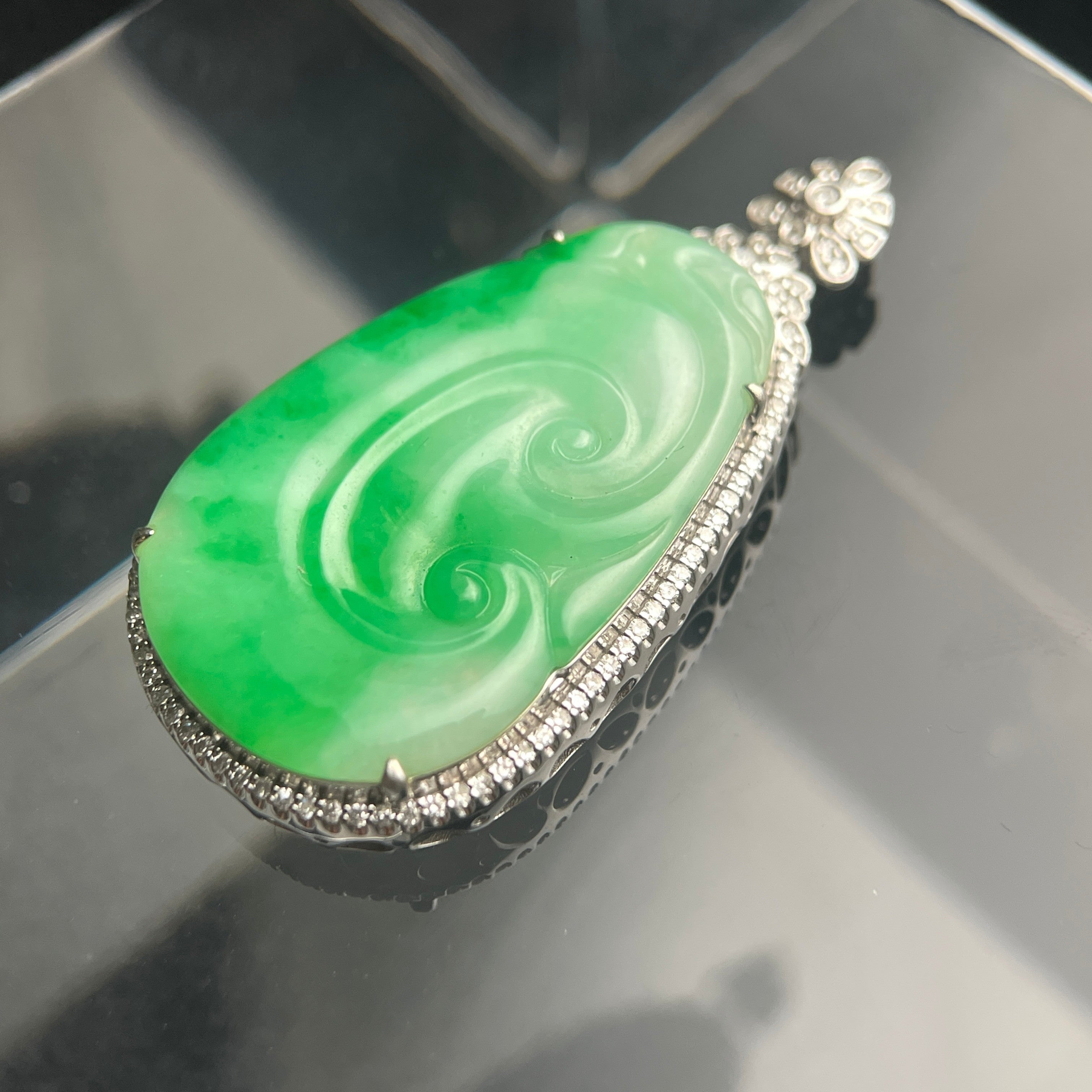 Sylvia Jewelry natural green Type A jadeite jade pendant with spiral carving and 18K gold diamond-accented setting.