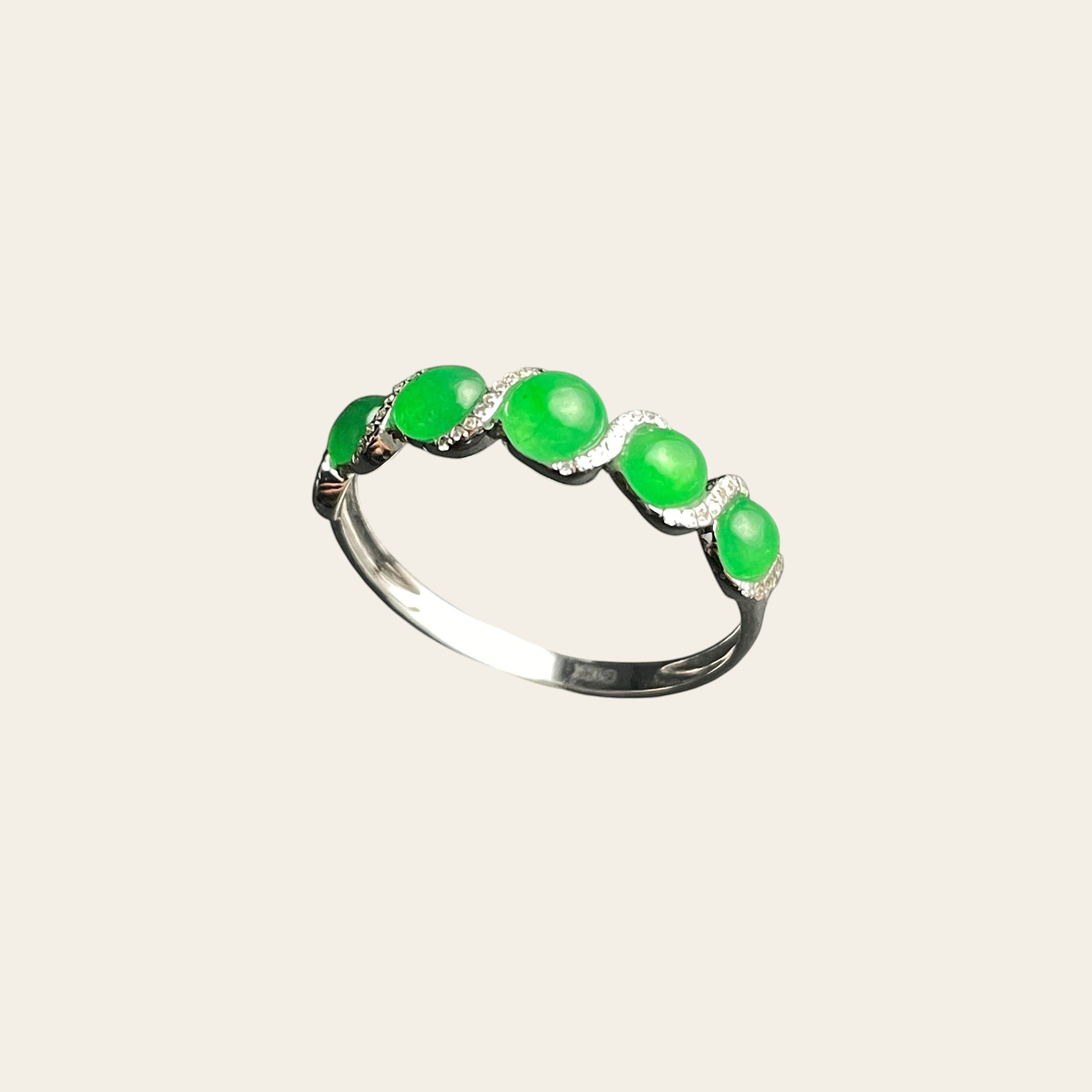 Sylvia Jewelry five-stone apple green jadeite ring in 18k white gold with diamond-encrusted wave motif.