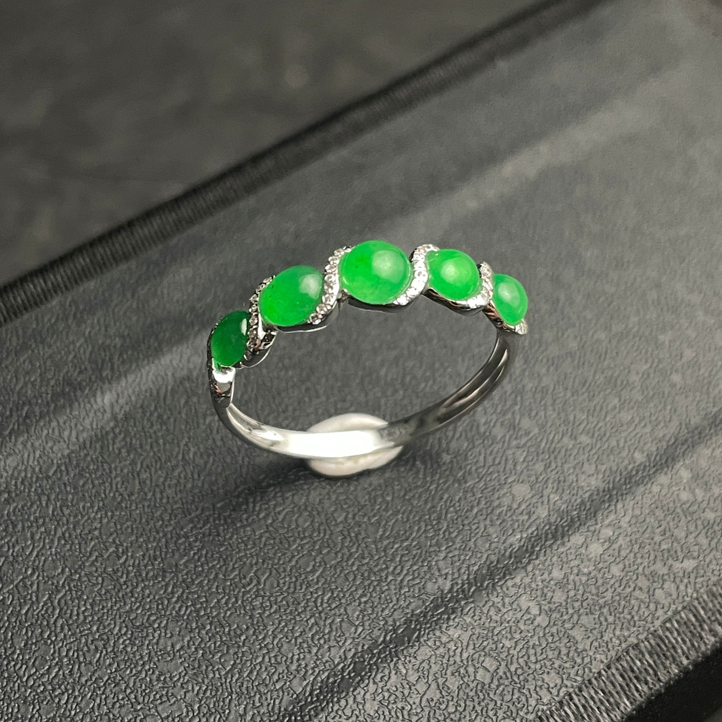 Sylvia Jewelry five-stone apple green jadeite ring in 18k white gold with diamond-encrusted wave motif.