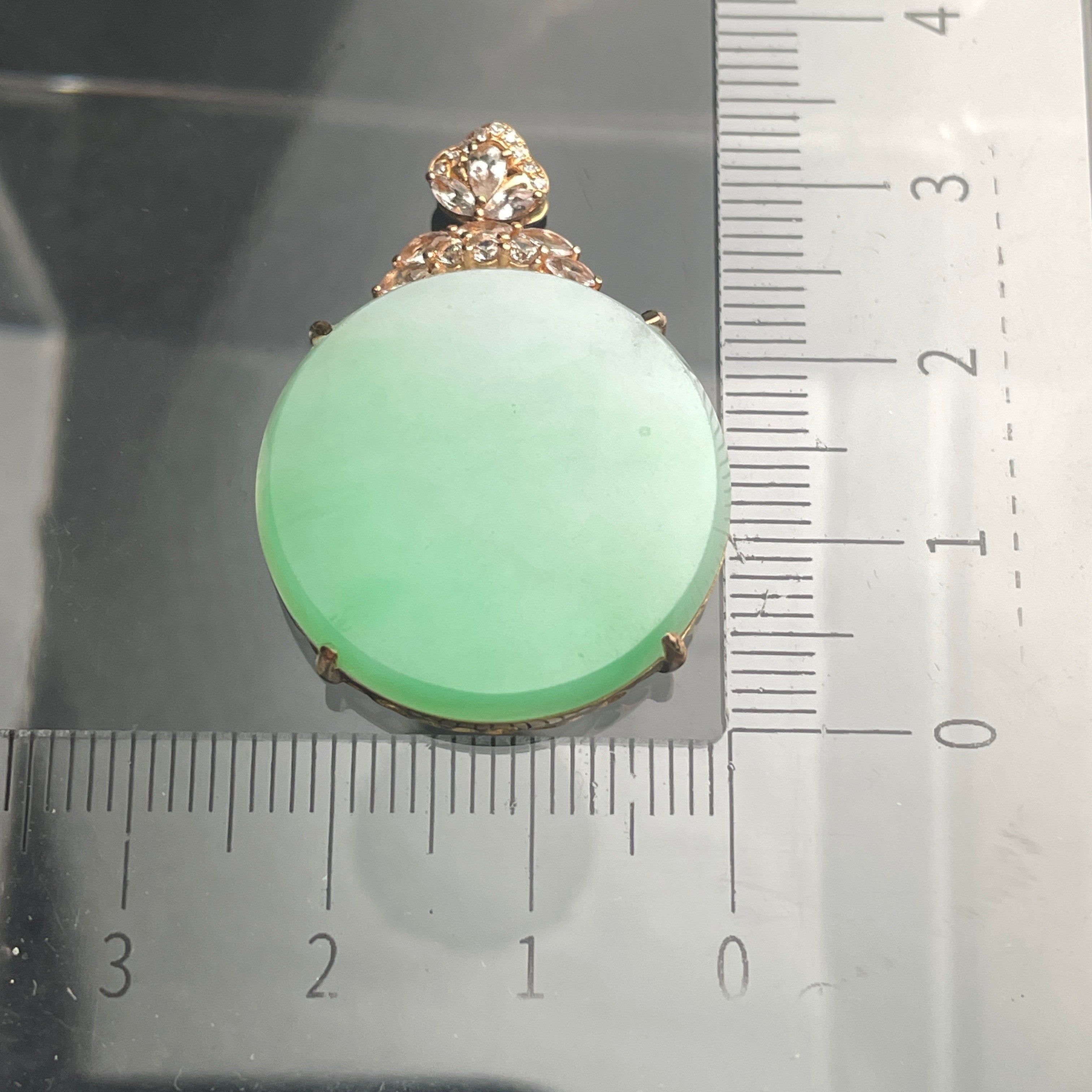 Sylvia Jewelry 18K rose gold pendant featuring a pale green jadeite oval cabochon with a floral diamond-accented bail.