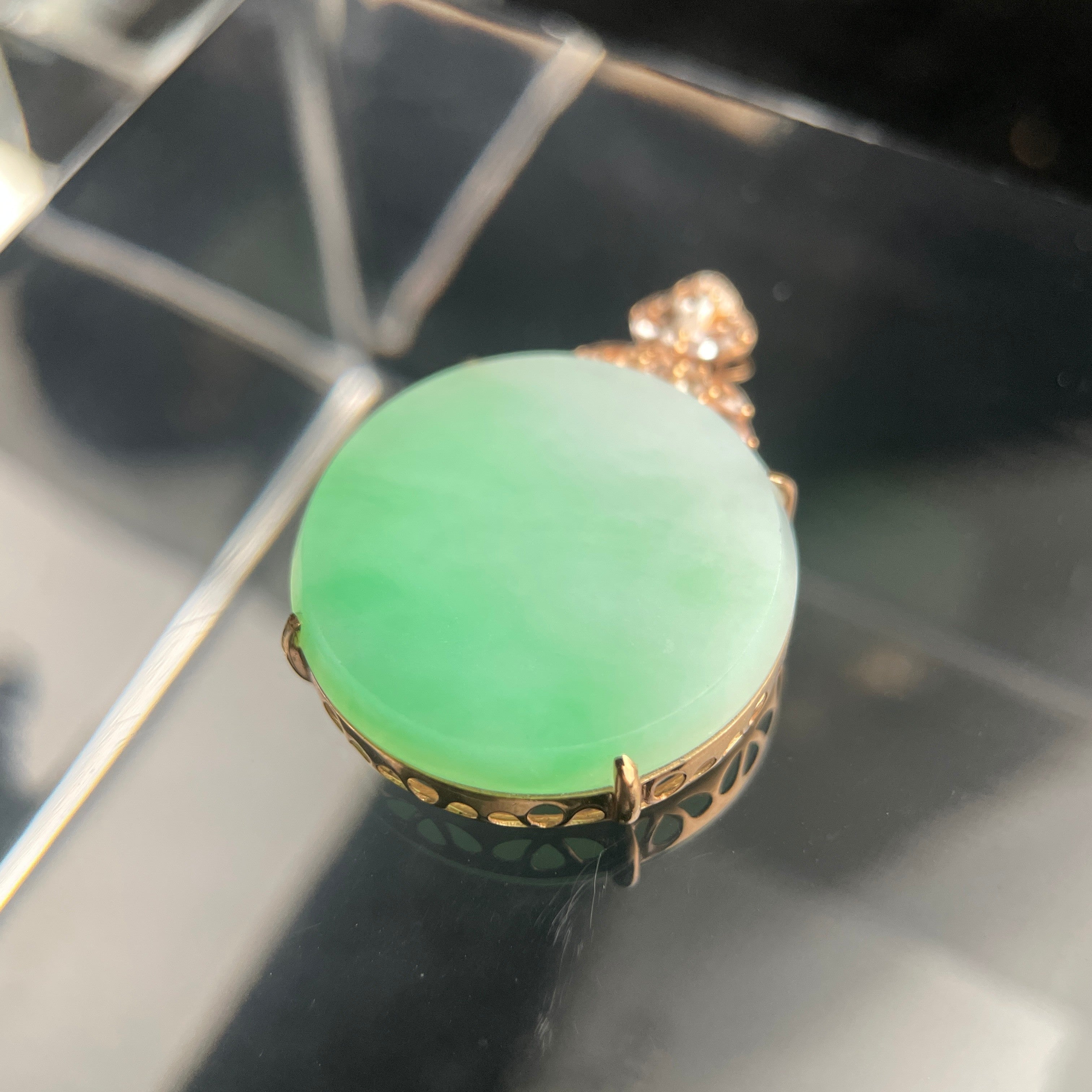 Sylvia Jewelry 18K rose gold pendant featuring a pale green jadeite cabochon with a floral diamond-accented bail.
