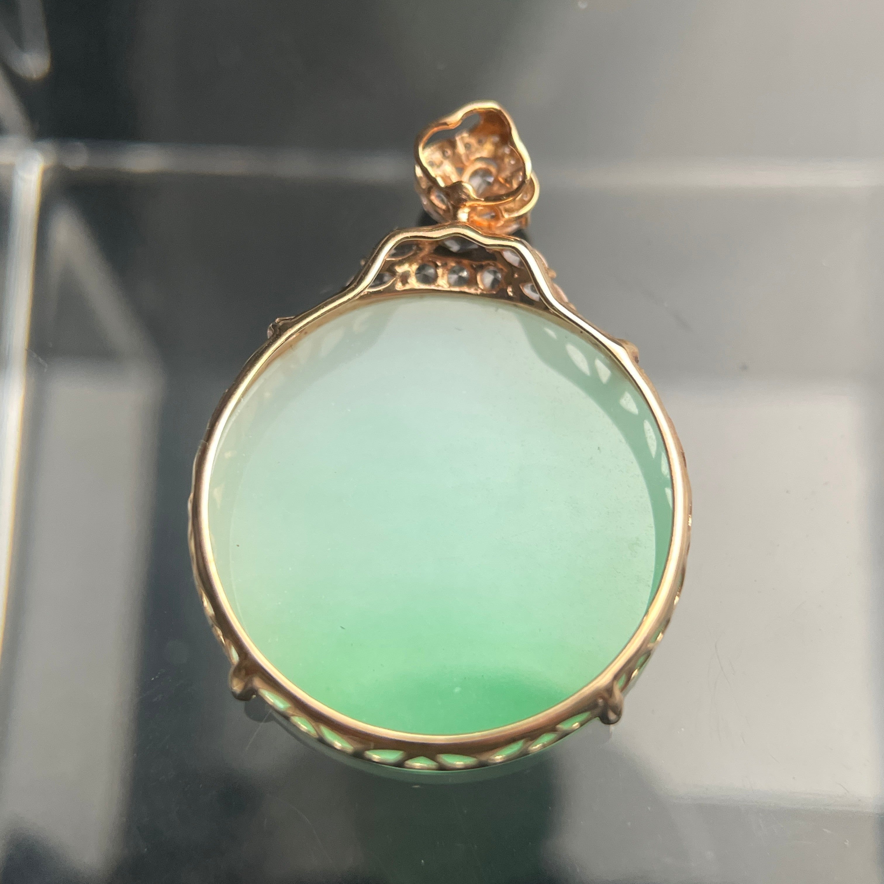 Sylvia Jewelry pale green jadeite oval pendant in 18K rose gold with a diamond-accented floral bail.