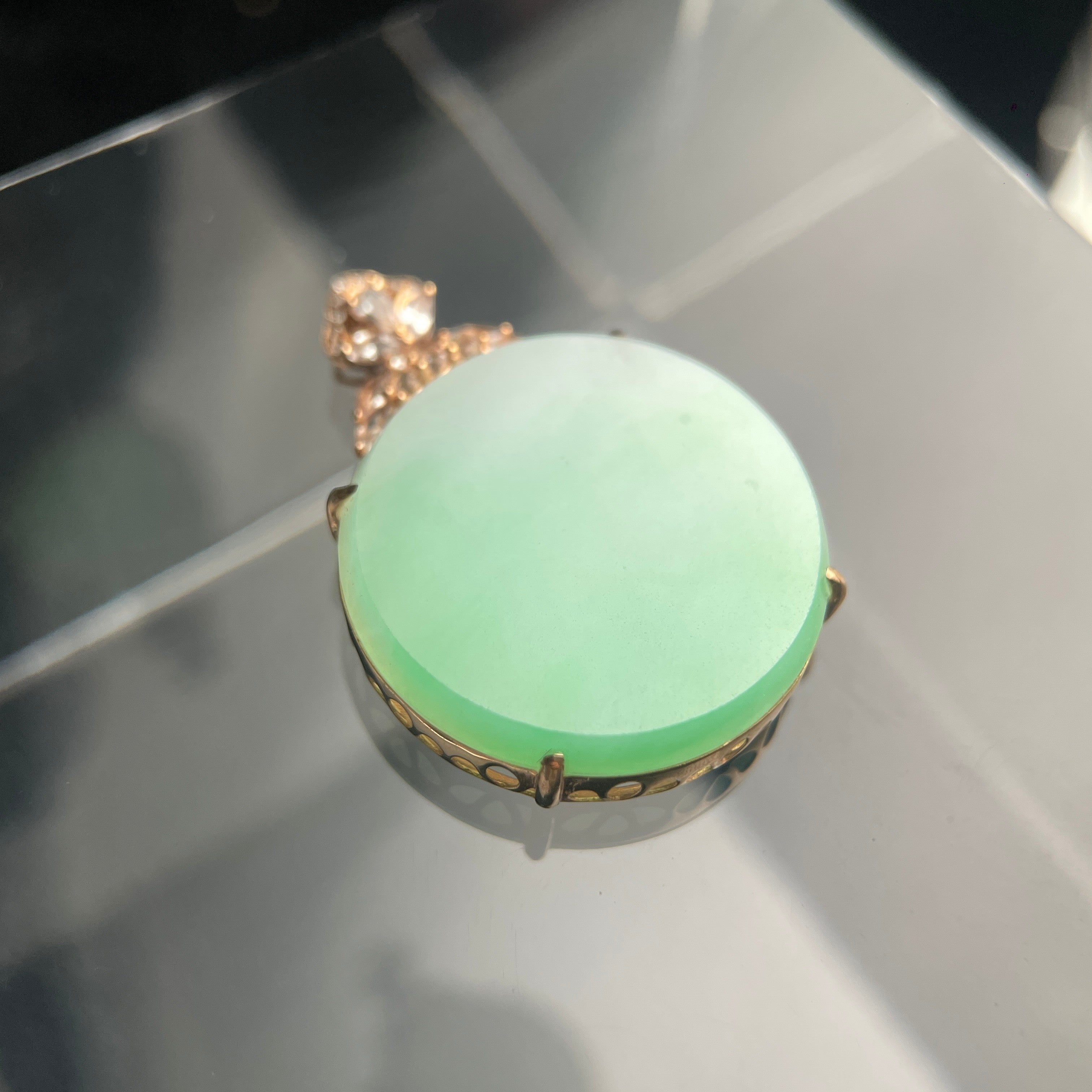 Sylvia Jewelry pale green jadeite oval pendant in 18K rose gold with a floral diamond-accented bail.