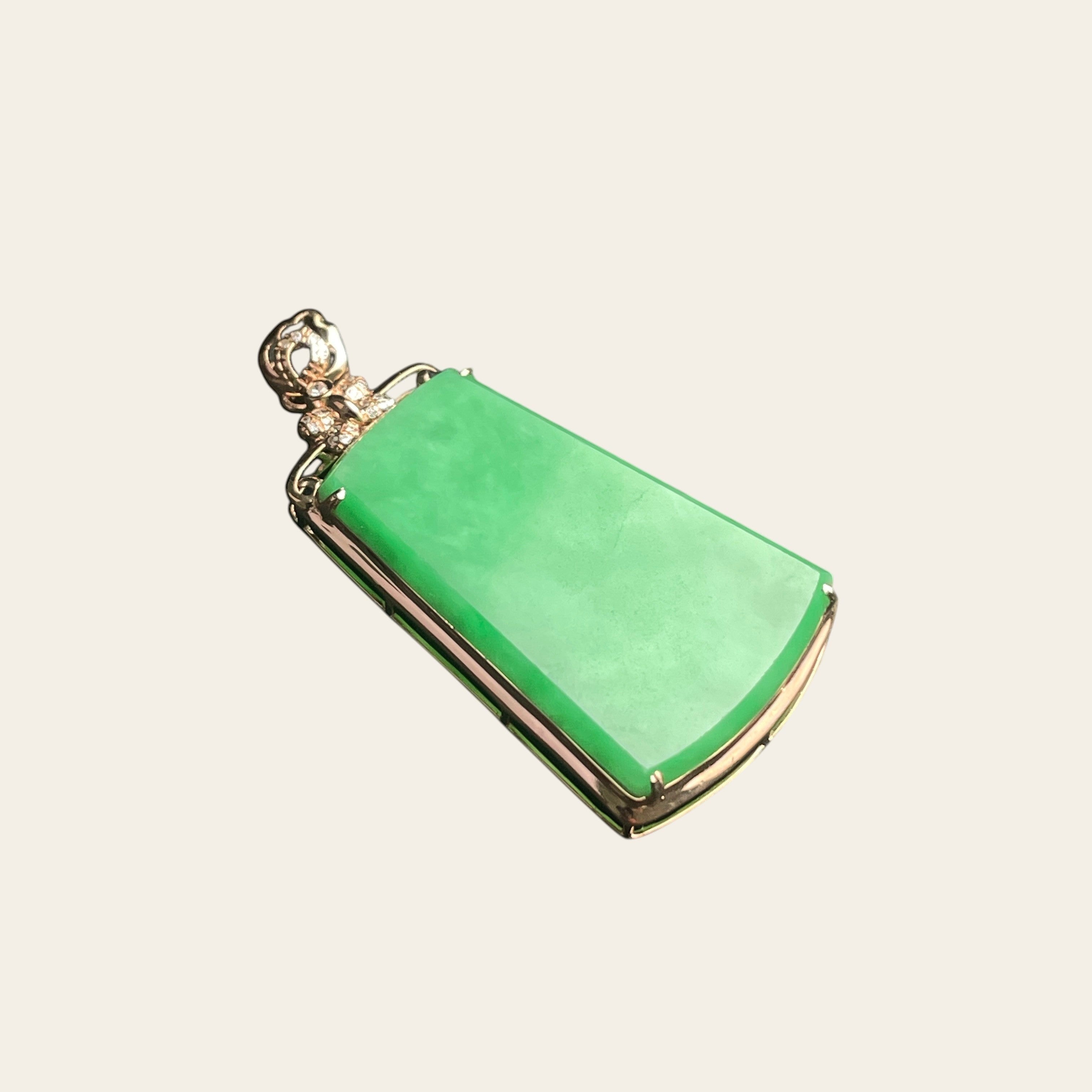 Sylvia Jewelry apple green jadeite trapezoid pendant in 18k gold with diamond accents on a minimalist bail.