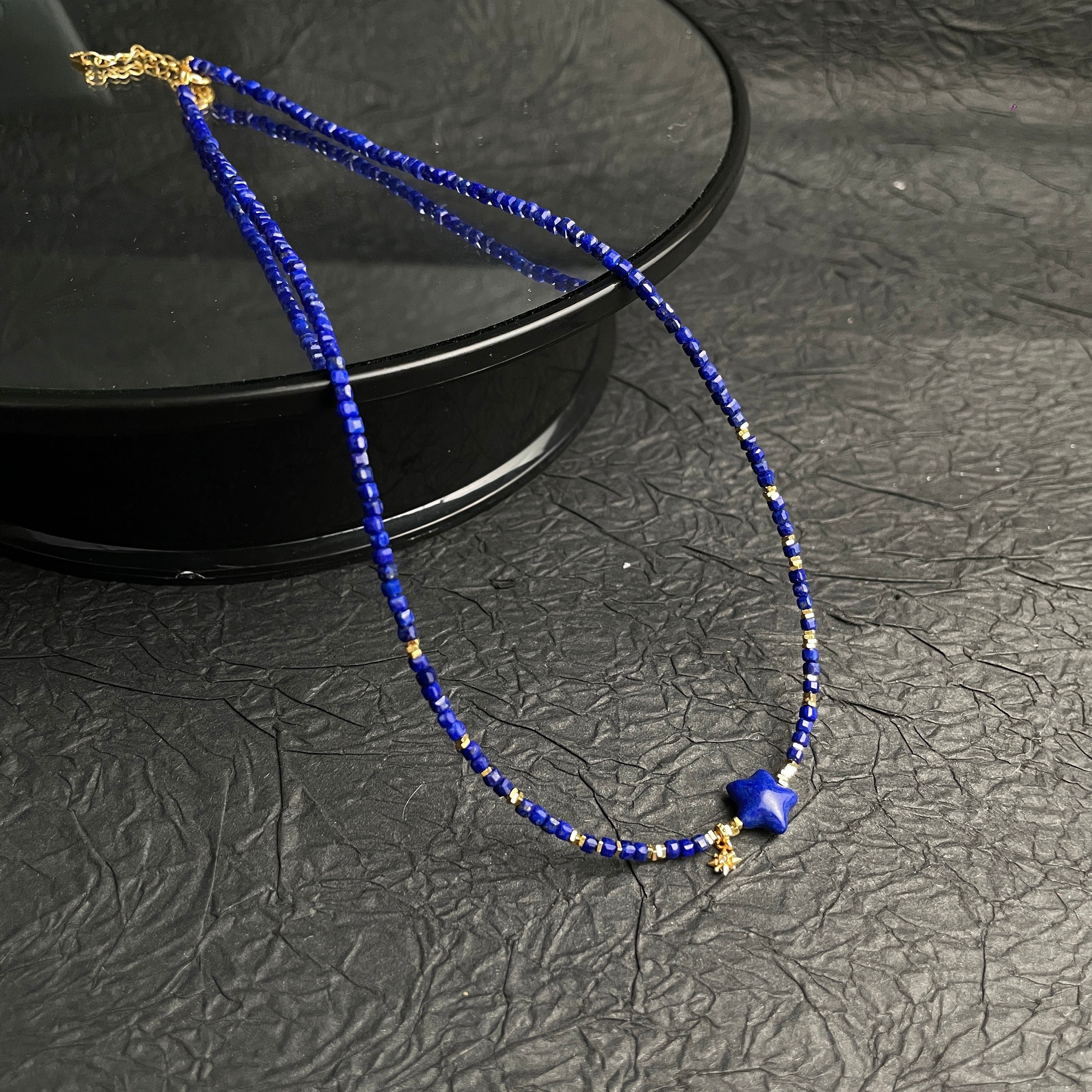 Sylvia Jewelry Celestial Night lapis lazuli beaded choker with gold-plated star pendant and delicate starburst charm.