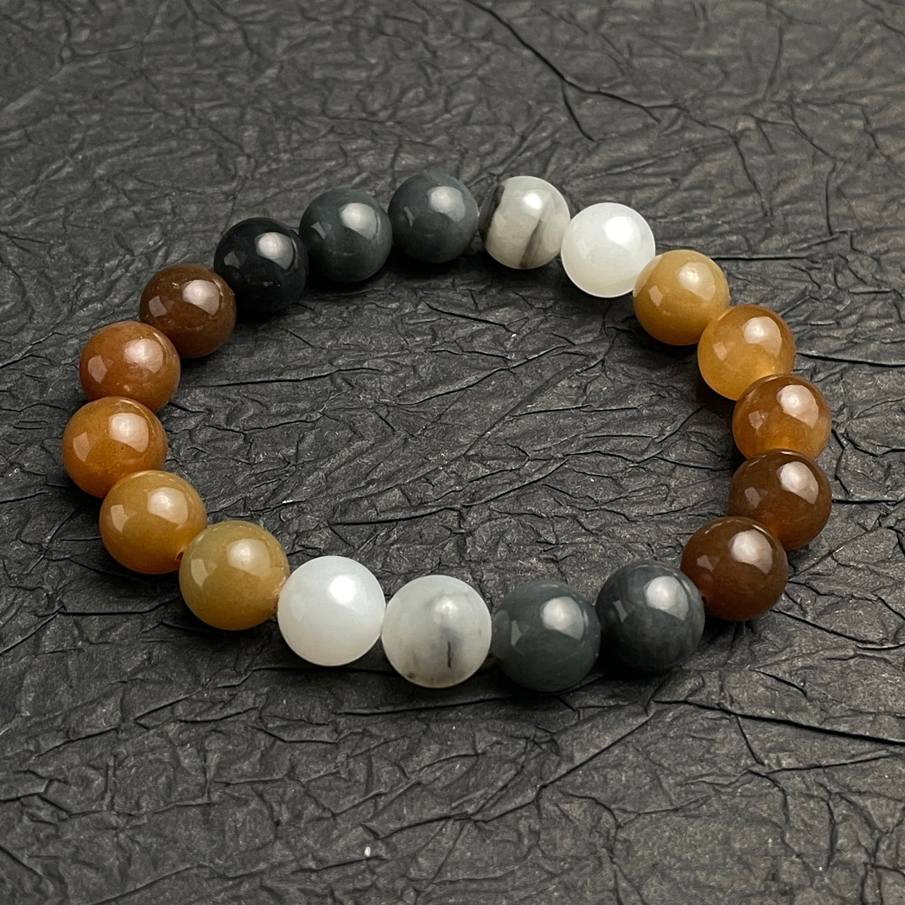 Sylvia Jewelry multi-colored Hetian nephrite jade bead bracelet with a gradient of brown, amber, white, and grey tones.
