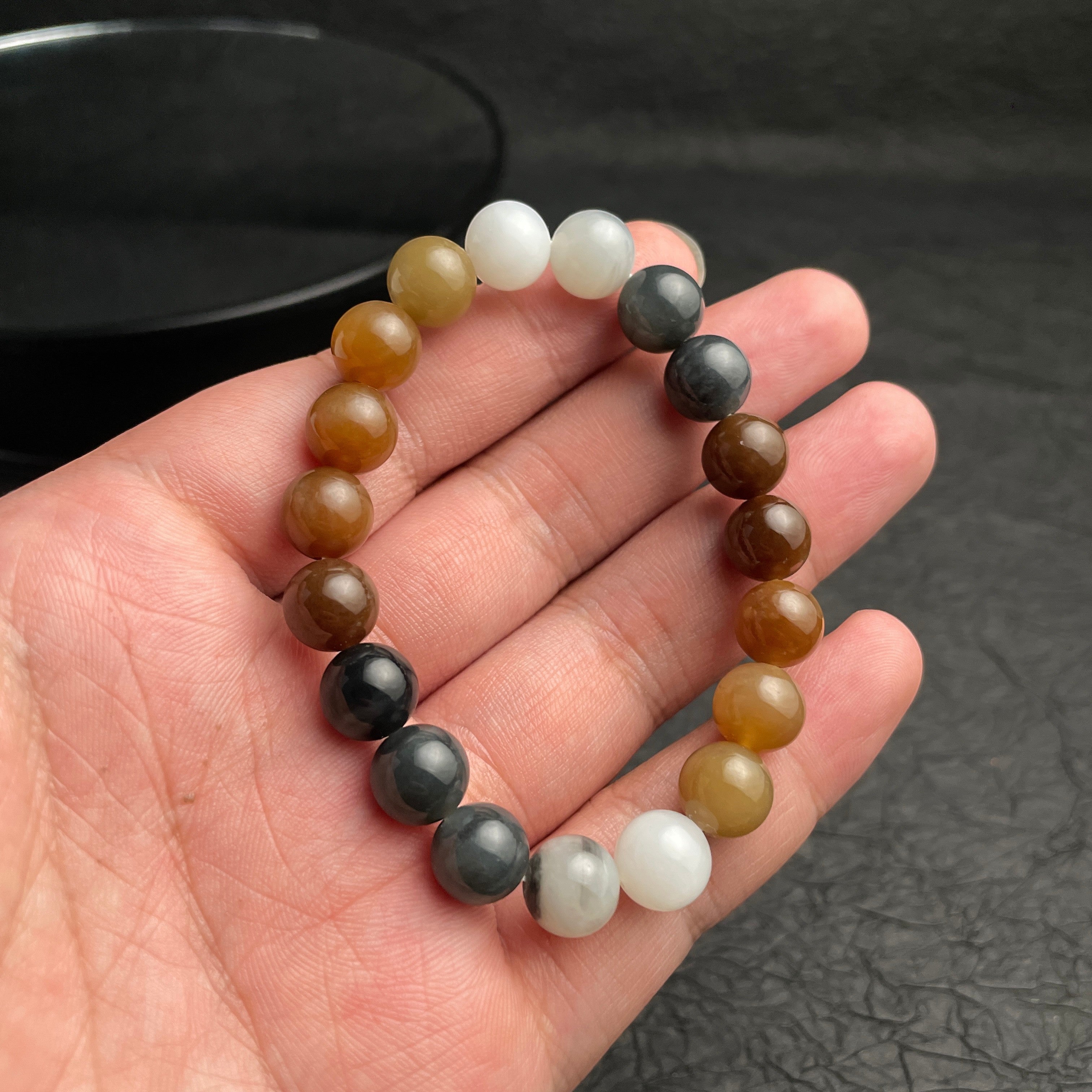Sylvia Jewelry multi-colored Hetian nephrite jade bead bracelet with a smooth, polished gradient finish on a hand.