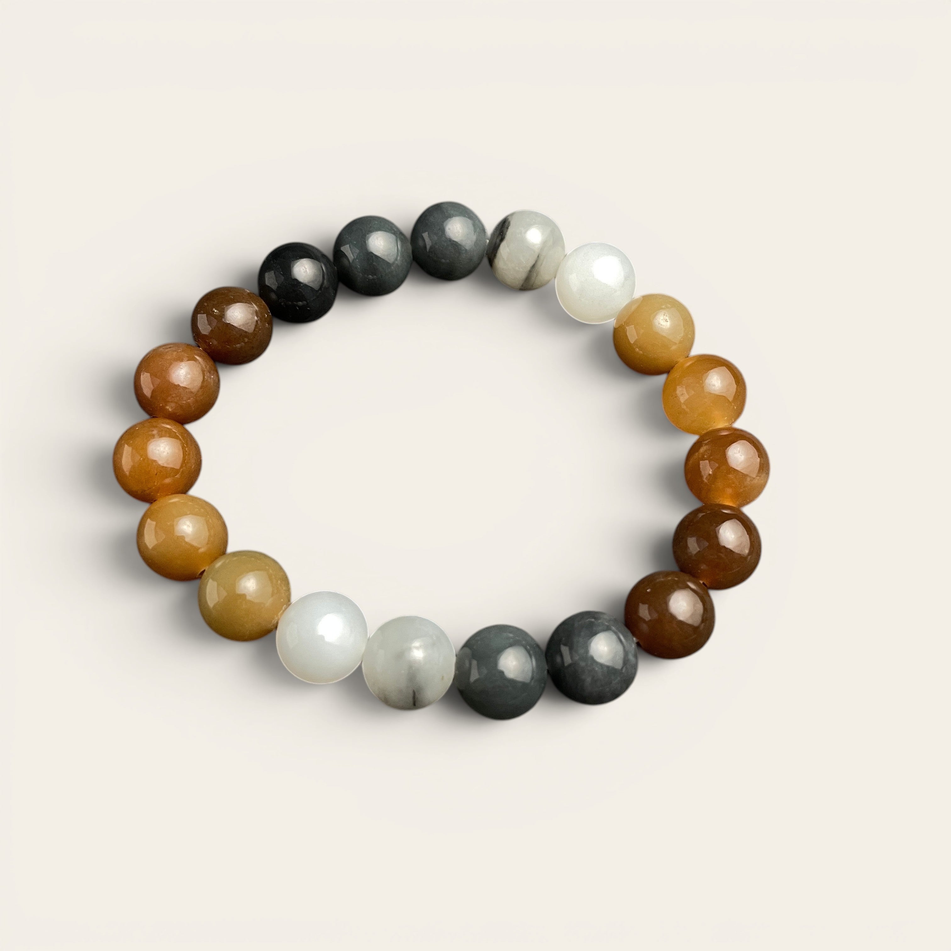 Sylvia Jewelry multi-colored Hetian nephrite jade bead bracelet featuring a gradient of brown, amber, white, and grey.