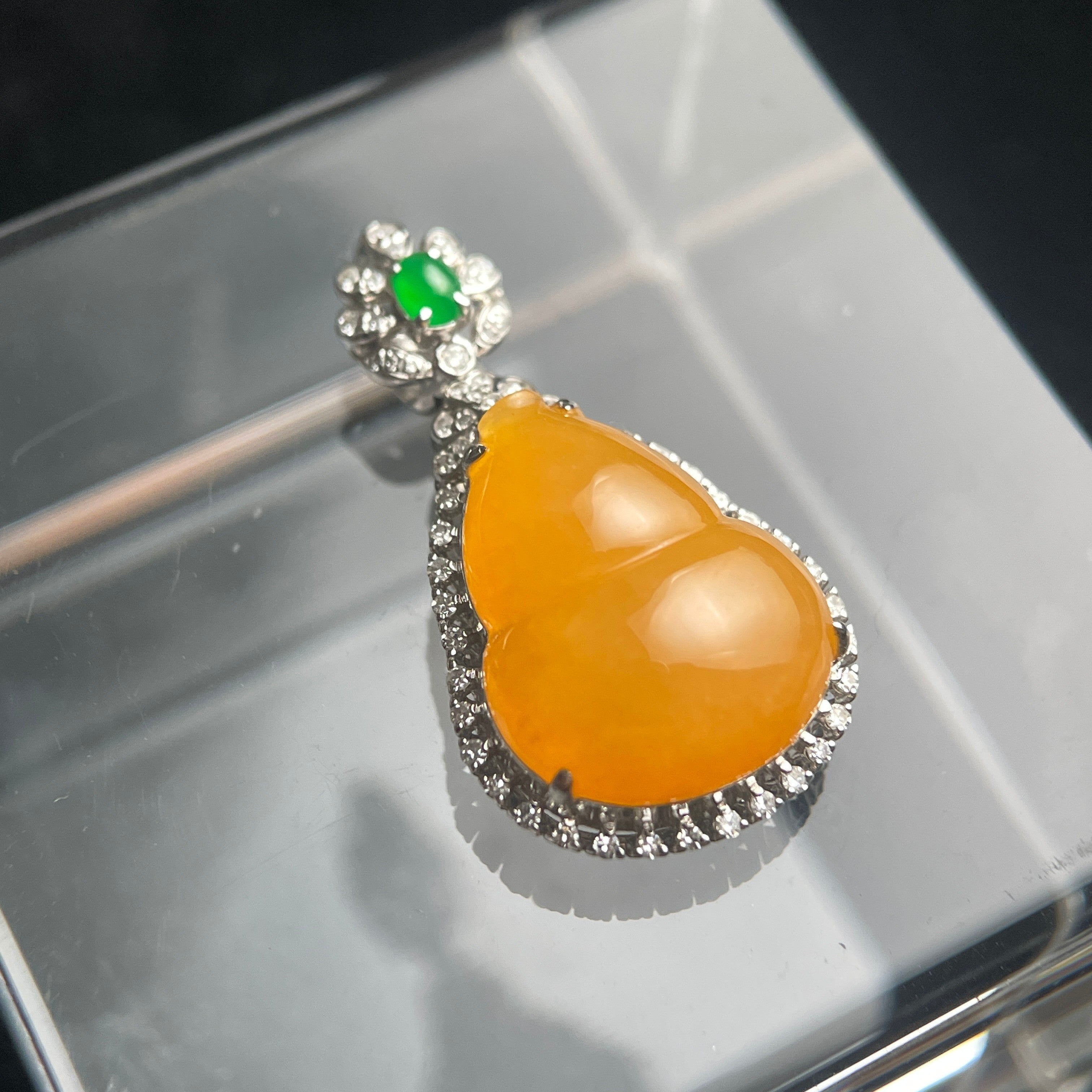 Sylvia Jewelry orange jadeite pendant in 18K gold with a green jade accent and diamond halo setting.