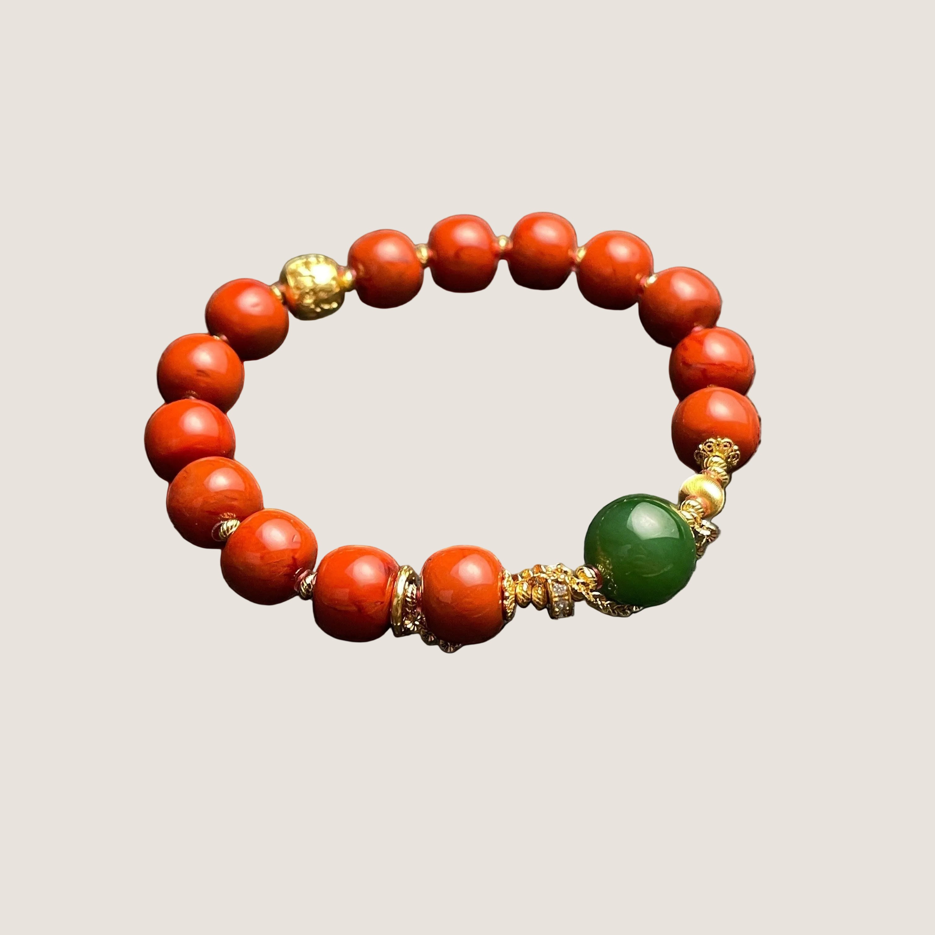 Sylvia Jewelry Nanhong Agate & Hetian Green Jade beaded bracelet with gold-plated accents. Features vibrant red agate beads and a central deep green jade bead.