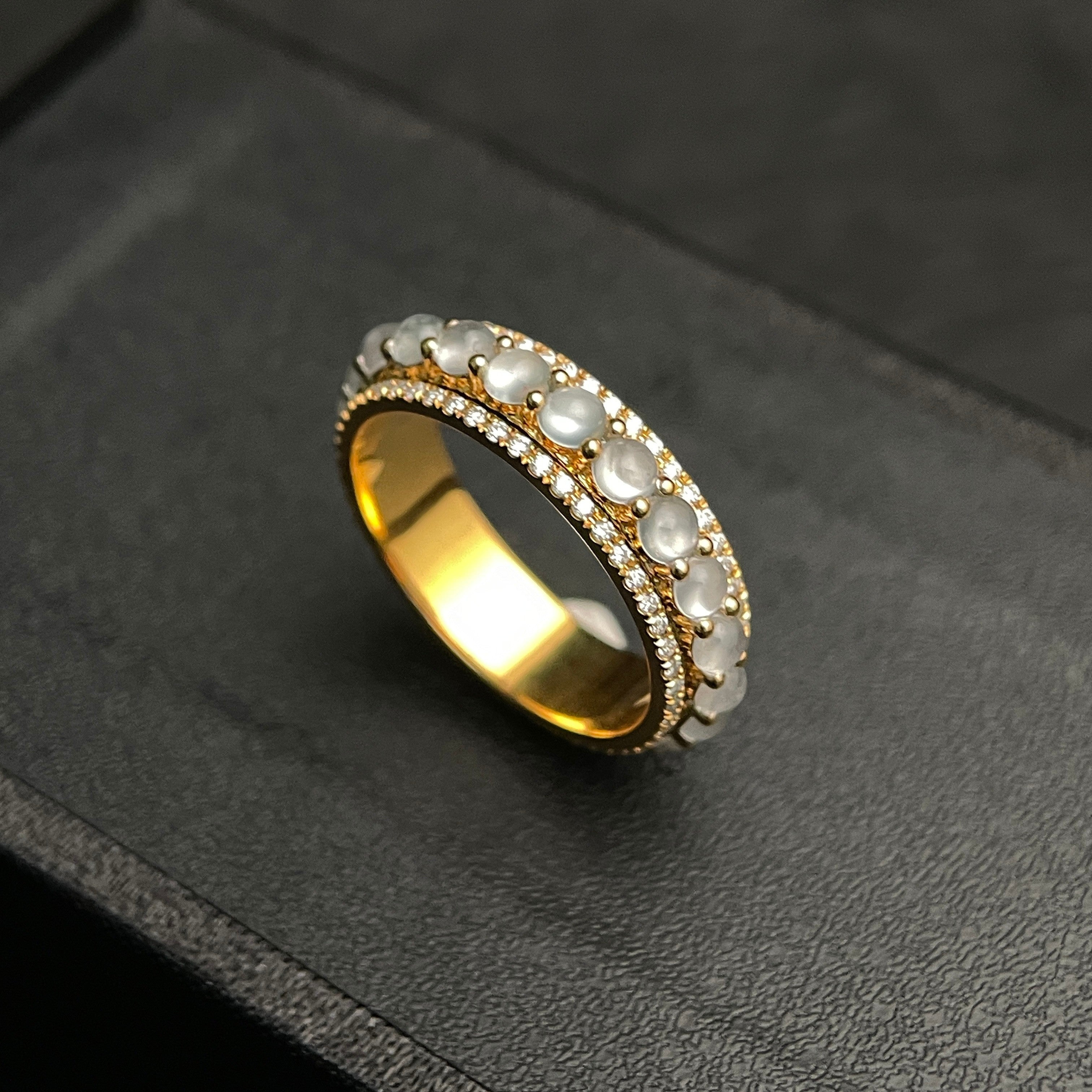 Sylvia Jewelry 18K gold rotating ring with white jadeite cabochons and small diamonds. Smooth, milky jadeite stones spin freely.