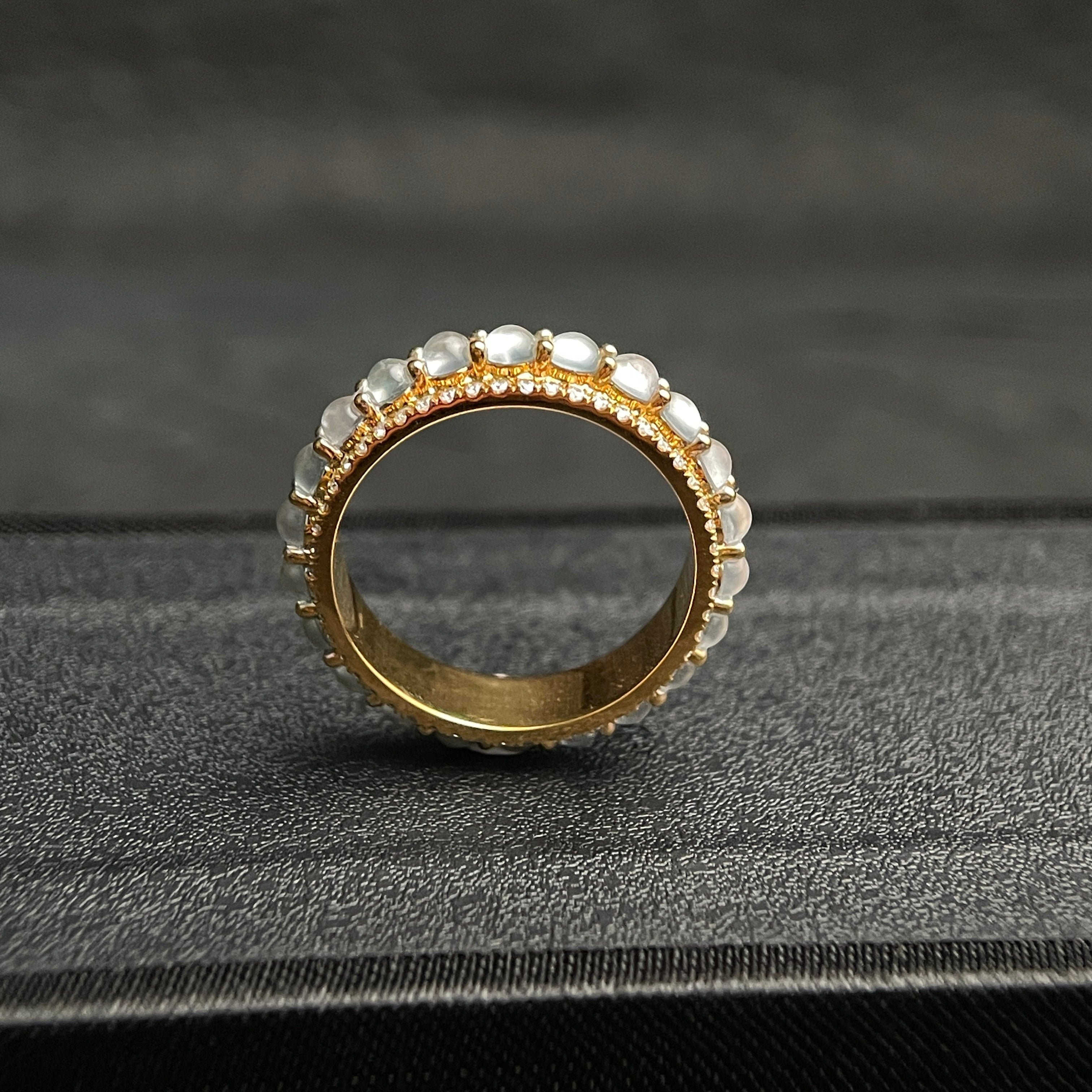 Sylvia Jewelry 18K gold band ring with rotating white jadeite cabochons and small diamonds.