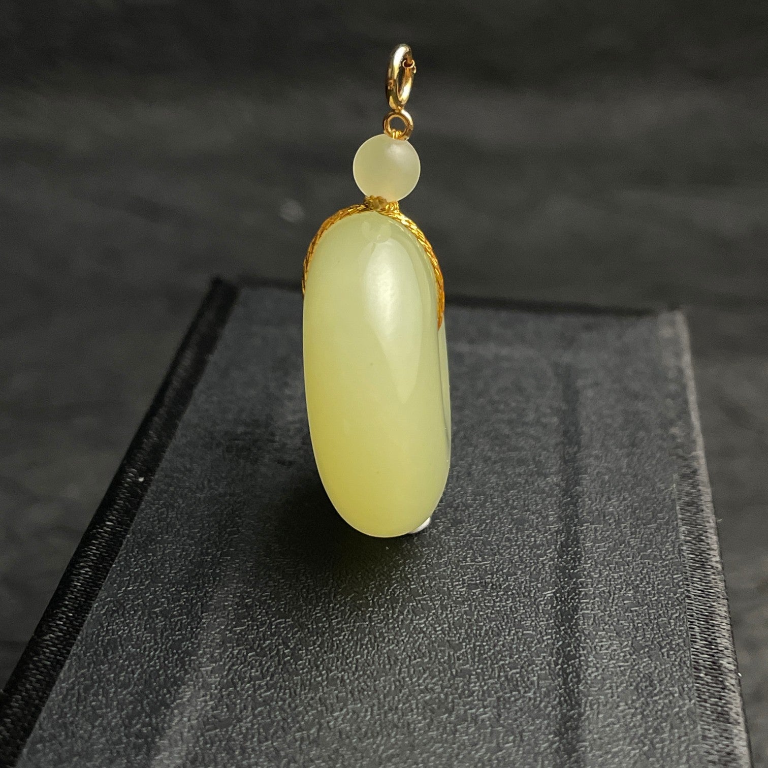 Sylvia Jewelry pale yellow Hetian jade Ping An Kou pendant with gold-plated silver hardware and a jade spacer bead.