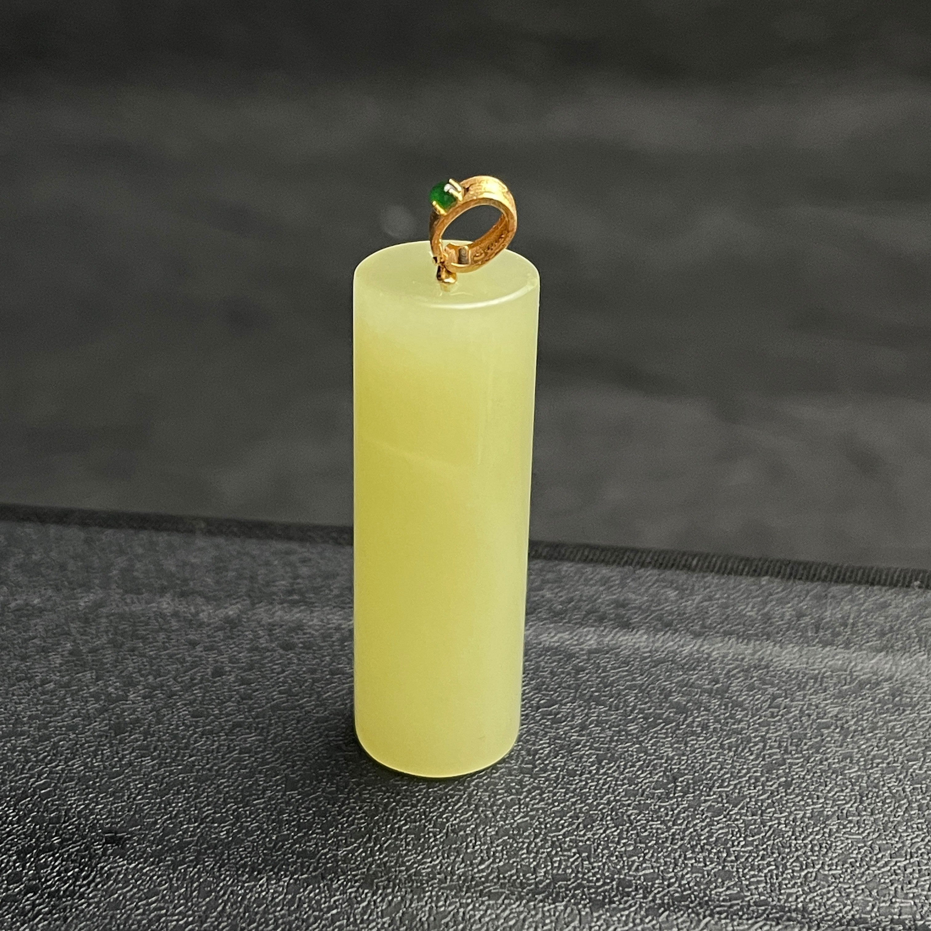 Sylvia Jewelry pale yellow Hetian jade cylinder pendant with a gold-plated bail and green jadeite accent.