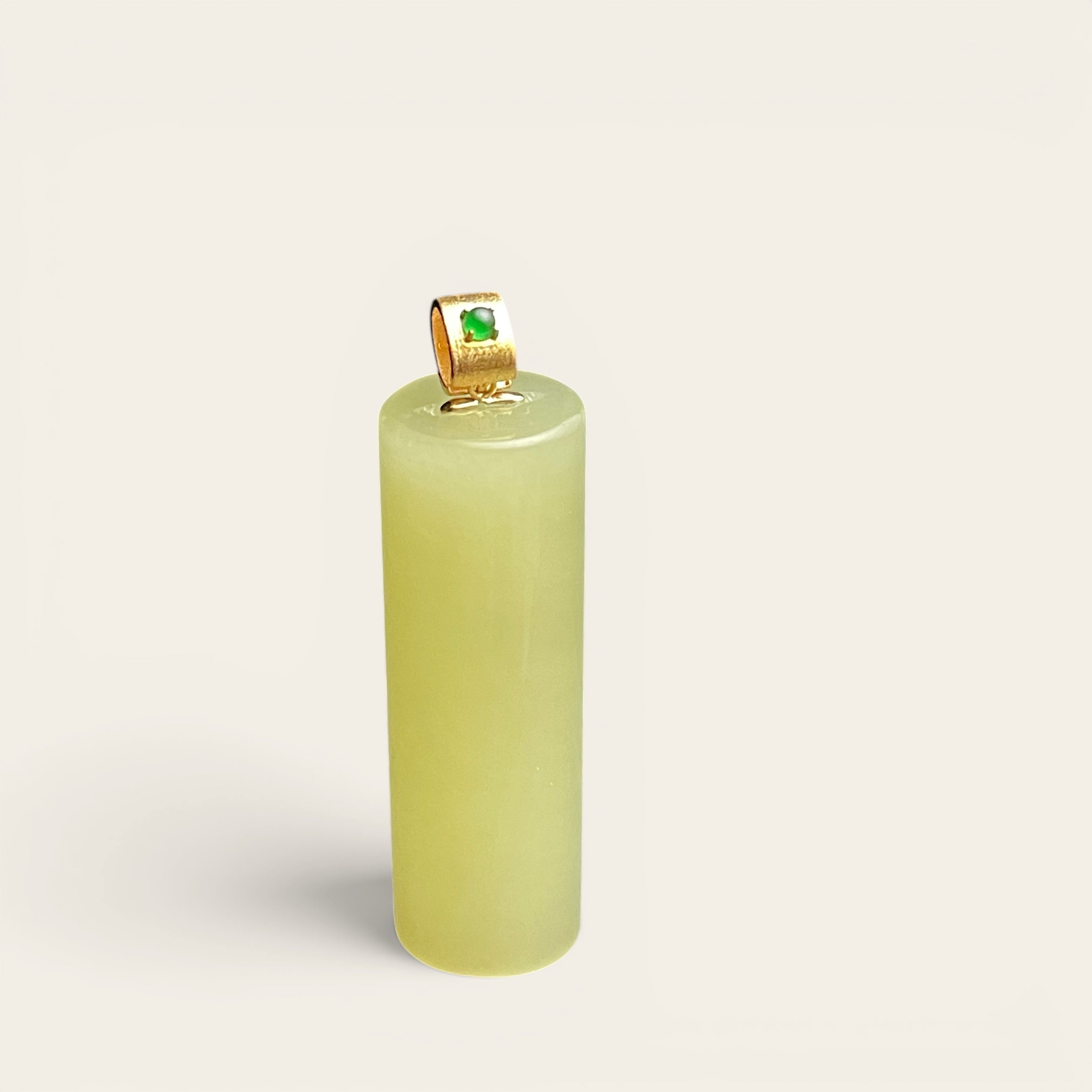 Sylvia Jewelry pale yellow Hetian jade cylinder pendant with a gold-plated bail and green jadeite accent.