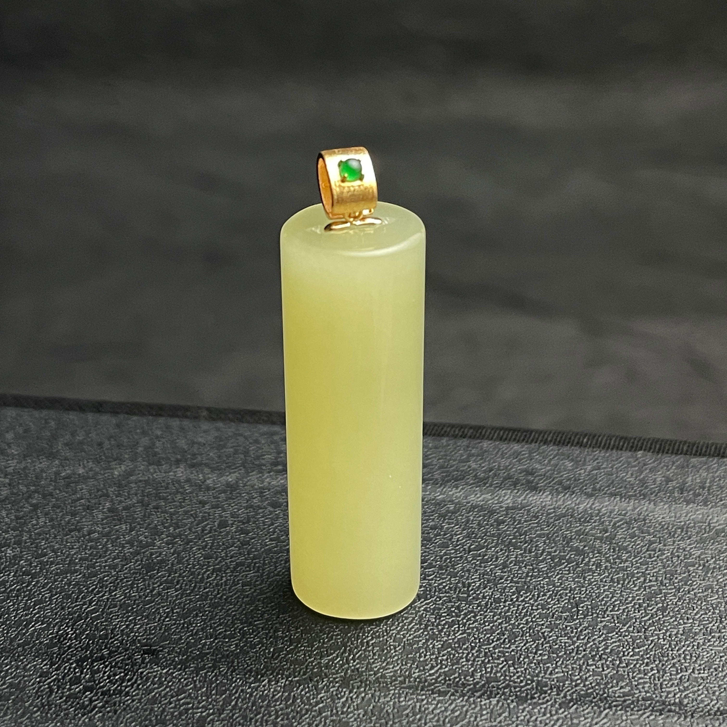 Sylvia Jewelry pale yellow Hetian jade cylinder pendant with a gold-plated bail and green jadeite accent stone.