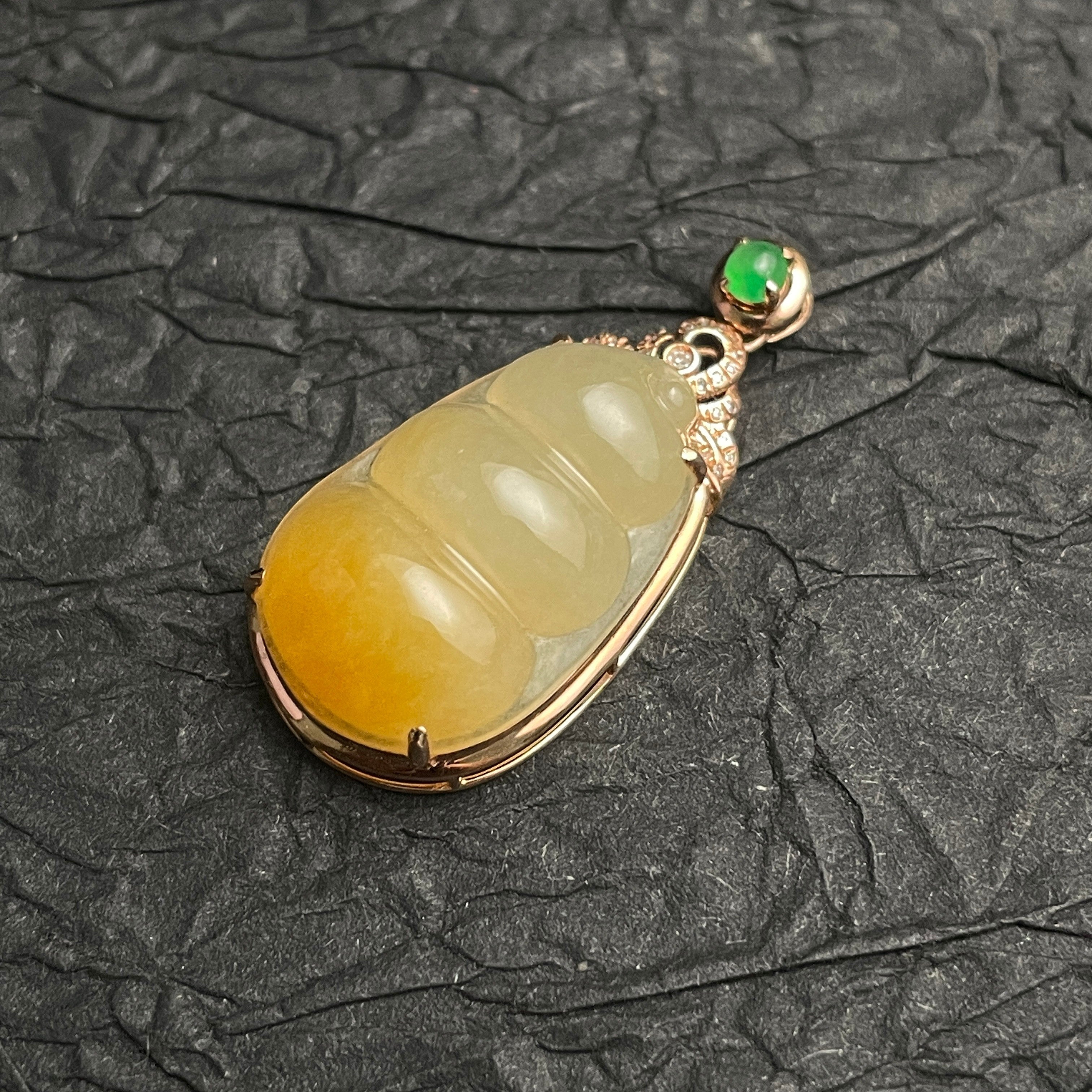 Sylvia Jewelry ice-species yellow jadeite Fortune Bean pendant with 18k gold, diamonds, and a green jadeite cabochon.