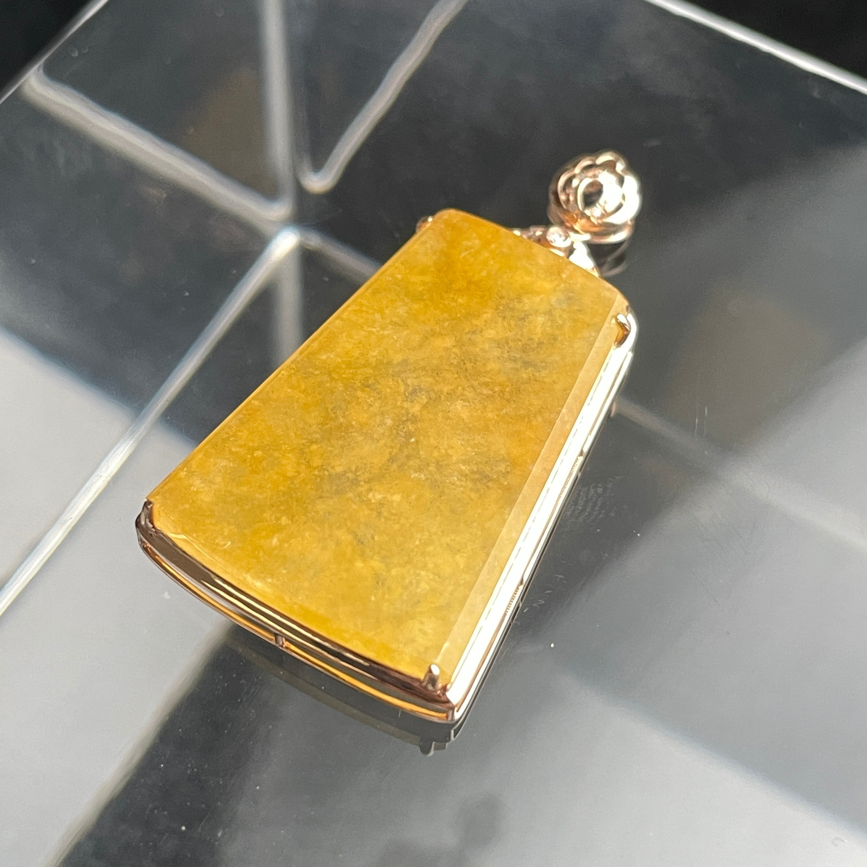 Sylvia Jewelry rectangular yellow jadeite jade pendant plaque set in polished 18K gold on a reflective surface