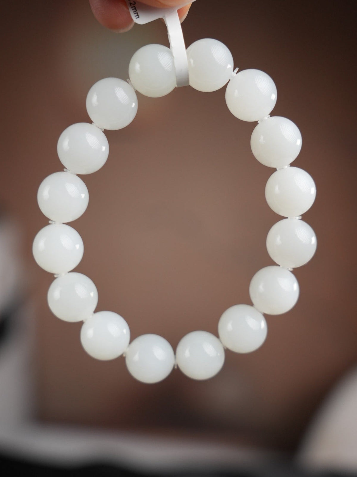 White Hetian nephrite jade bracelet showing 12 mm bead measurement, B12609024891